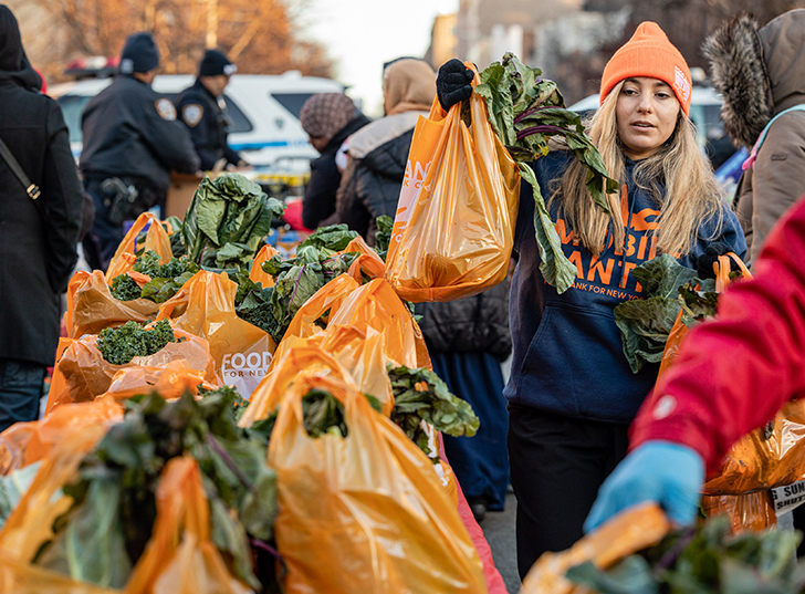 A volunteer organizing bags of vegetables. Links to Beneficiary Designations designatins.jpg