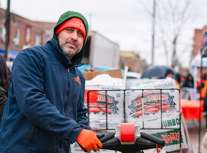 A man pushing a load of sweet potatoes. Links to Gifts of Appreciated Securities securities.jpg